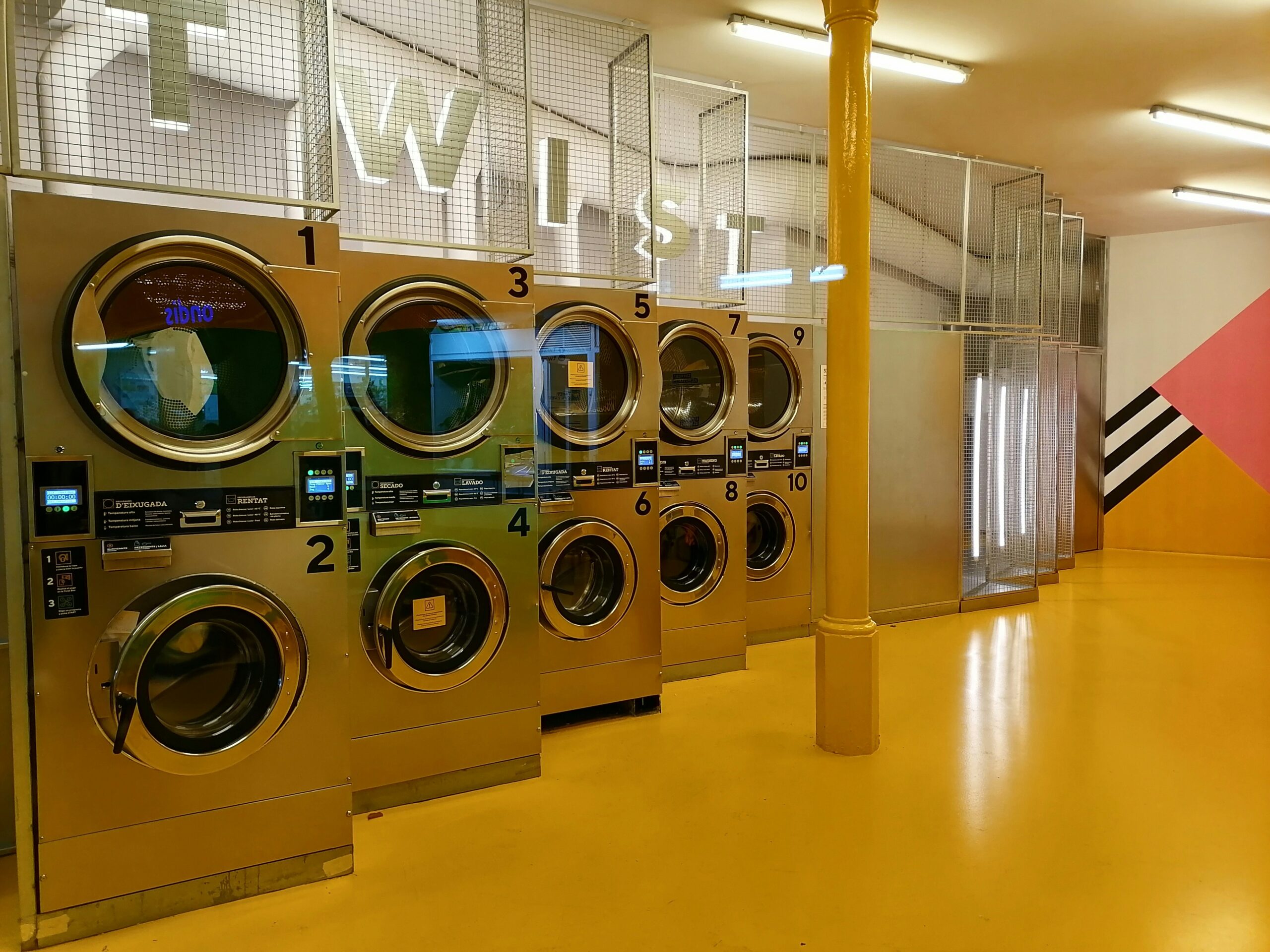 a row of washing machines in a public laundment